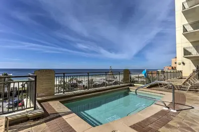 a swimming pool with a view of the ocean at Scenic PCB Condo with Stunning Sunsets and Beach View! in Panama City Beach