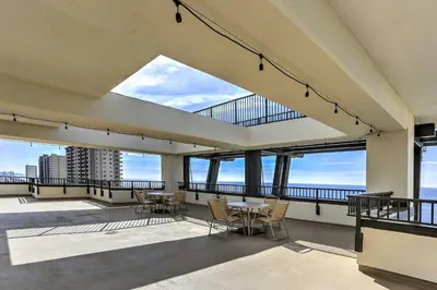 a view from the balcony of a building with tables and chairs at Scenic PCB Condo with Stunning Sunsets and Beach View! in Panama City Beach