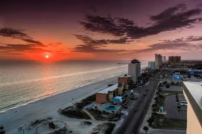 an aerial view of a beach at sunset at Scenic PCB Condo with Stunning Sunsets and Beach View! in Panama City Beach