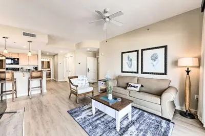 a living room with a couch and a table at Scenic PCB Condo with Stunning Sunsets and Beach View! in Panama City Beach