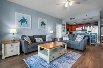 a living room with a couch and a table at Laketown Wharf 1626 in Panama City Beach