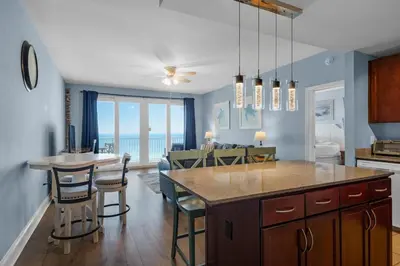 a kitchen and dining room with a view of the ocean at Laketown Wharf 1626 in Panama City Beach