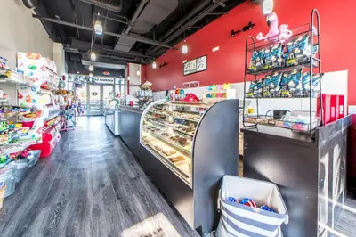 a store with red walls and a counter with pastries at Laketown Wharf 1626 in Panama City Beach