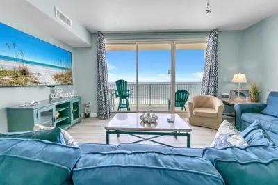 a living room with a couch and a table at Shores of Panama 830 in Panama City Beach