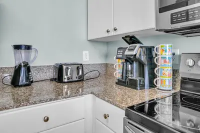 a kitchen counter with a coffee maker and a blender at Shores of Panama 830 in Panama City Beach