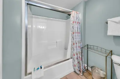 a shower in a bathroom with a shower curtain at Shores of Panama 830 in Panama City Beach