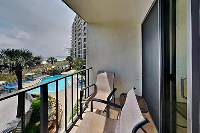 a balcony with two chairs and a view of the ocean at Edgewater Tower II #205 in Panama City Beach