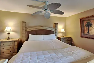a bedroom with a bed with a ceiling fan at Edgewater Tower II #205 in Panama City Beach