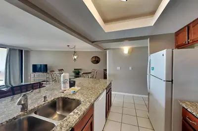 a kitchen with a sink and a refrigerator at Edgewater Tower II #205 in Panama City Beach