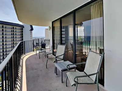 a row of chairs sitting on a balcony at Edgewater Tower I 912 in Panama City Beach