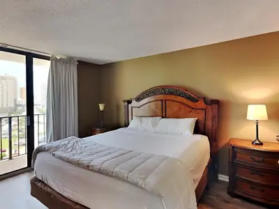 a bedroom with a large bed and a large window at Edgewater Tower I 912 in Panama City Beach