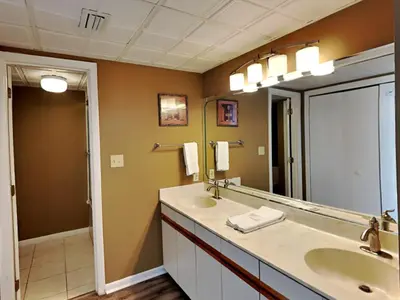 a bathroom with two sinks and a large mirror at Edgewater Tower I 912 in Panama City Beach