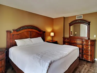 a bedroom with a large bed and a large mirror at Edgewater Tower I 912 in Panama City Beach