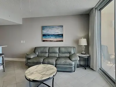a living room with a couch and a table at Majestic Beach Towers I #1111 in Panama City Beach