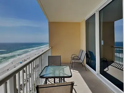 a balcony with a table and chairs and the beach at Majestic Beach Towers I #1111 in Panama City Beach