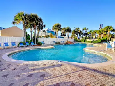 a swimming pool in a resort with palm trees at Majestic Beach Towers I #1111 in Panama City Beach