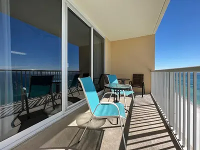 a balcony with chairs and a table on a balcony at Majestic Beach Towers I #2210 in Panama City Beach