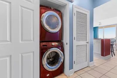 a washer and dryer in a room next to a door at Majestic Beach Towers I #2210 in Panama City Beach