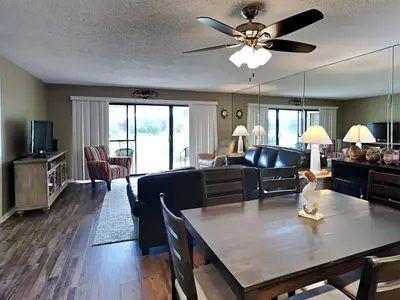 a living room with a table and a couch at Edgewater Villa #2605 in Panama City Beach