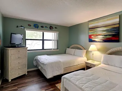 a bedroom with two beds and a window at Edgewater Villa #2605 in Panama City Beach