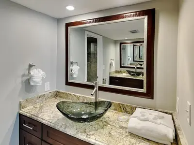 a bathroom with a sink and a large mirror at Edgewater Tower Iii 301 in Panama City Beach