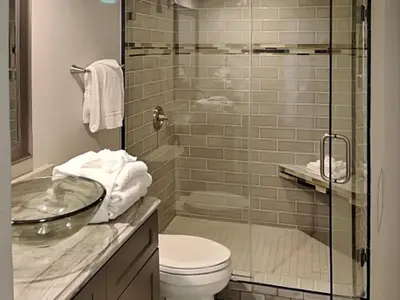 a bathroom with a toilet and a glass shower at Edgewater Tower Iii 301 in Panama City Beach