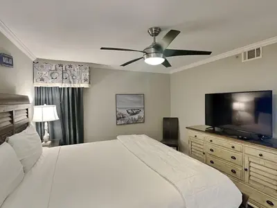 a bedroom with a bed and a flat screen tv at Edgewater Tower Iii 301 in Panama City Beach