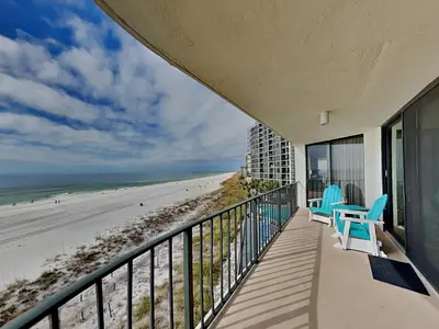 a balcony with two chairs and a view of the beach at Edgewater Tower Iii 301 in Panama City Beach