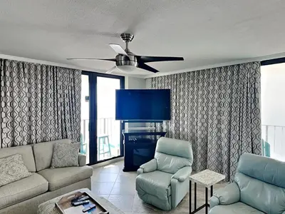 a living room with a couch and a ceiling fan at Edgewater Tower Iii 301 in Panama City Beach