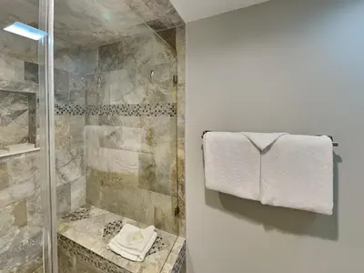 a bathroom with a shower with a towel on the wall at Edgewater Tower Iii 301 in Panama City Beach