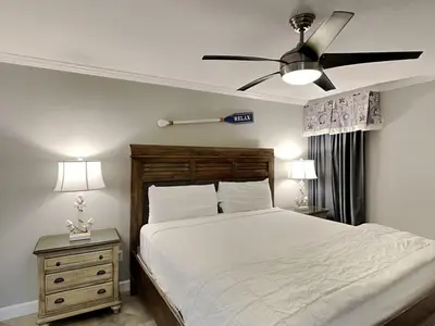 a bedroom with a bed and a ceiling fan at Edgewater Tower Iii 301 in Panama City Beach