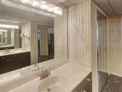 a bathroom with a sink and a large mirror at Edgewater Tower 1 Unit 101 in Panama City Beach