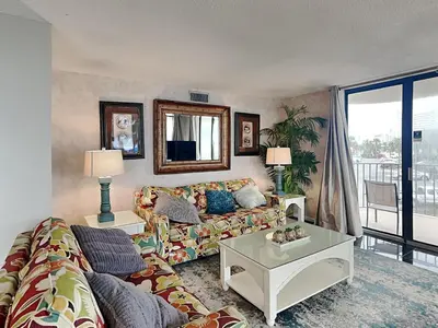 a living room with a couch and a table at Edgewater Tower 1 Unit 101 in Panama City Beach