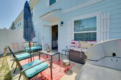 a patio with chairs and a table and a window at Beautiful PCB Getaway Less Than 3 Mi to the Beach! in Panama City Beach