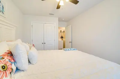 a bedroom with a large bed with a ceiling fan at Beautiful PCB Getaway Less Than 3 Mi to the Beach! in Panama City Beach