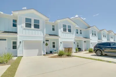 a row of houses with a car parked in a driveway at Beautiful PCB Getaway Less Than 3 Mi to the Beach! in Panama City Beach