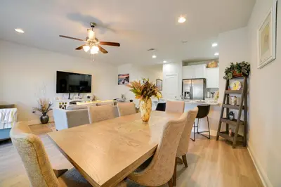 a dining room and living room with a table and chairs at Beautiful PCB Getaway Less Than 3 Mi to the Beach! in Panama City Beach