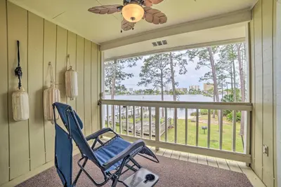 a blue rocking chair in a room with a window at 2 Mi to Beach! Bayside PCB Escape with Pool Access in Panama City Beach