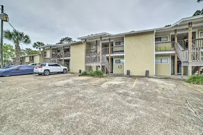 a parking lot in front of a apartment complex at 2 Mi to Beach! Bayside PCB Escape with Pool Access in Panama City Beach