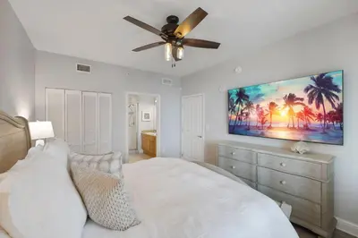 a bedroom with a bed and a ceiling fan at Totally Beach'n at 1605 Aqua in Panama City Beach