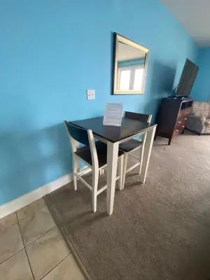 a dining room table with two chairs and a mirror at 1717 Laketown Wharf 1 King Bedroom, 2 Bath in Panama City Beach