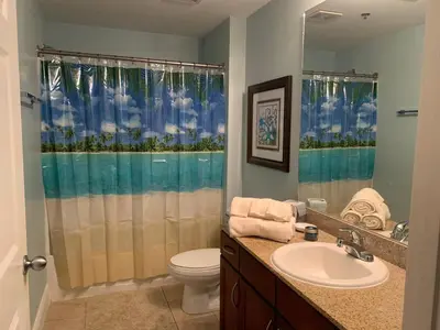 a bathroom with a sink and a toilet and a shower at 1717 Laketown Wharf 1 King Bedroom, 2 Bath in Panama City Beach