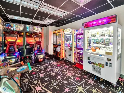 a gaming room with arcade games and consoles at Tidewater 302 in Panama City Beach