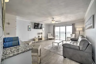 a living room with a couch and a table at Oceanfront Panama City Beach Condo with Pool Access in Panama City Beach