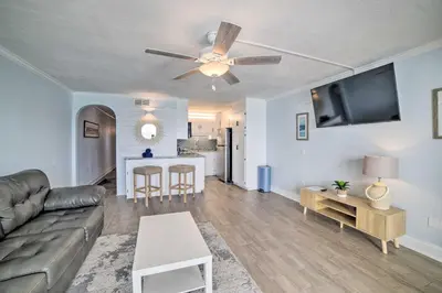 a living room with a couch and a table at Oceanfront Panama City Beach Condo with Pool Access in Panama City Beach