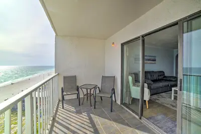 a balcony with a table and chairs and the ocean at Oceanfront Panama City Beach Condo with Pool Access in Panama City Beach