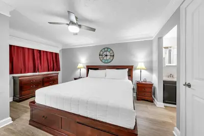 a bedroom with a bed and a clock on the wall at The Summit 1323 in Panama City Beach