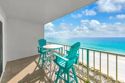 a balcony with a table and chairs and the ocean at The Summit 1323 in Panama City Beach