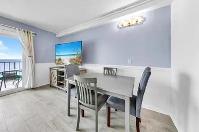 a dining room with a table and chairs at The Summit 928 in Panama City Beach