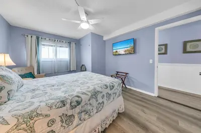 a bedroom with a bed and a ceiling fan at The Summit 928 in Panama City Beach